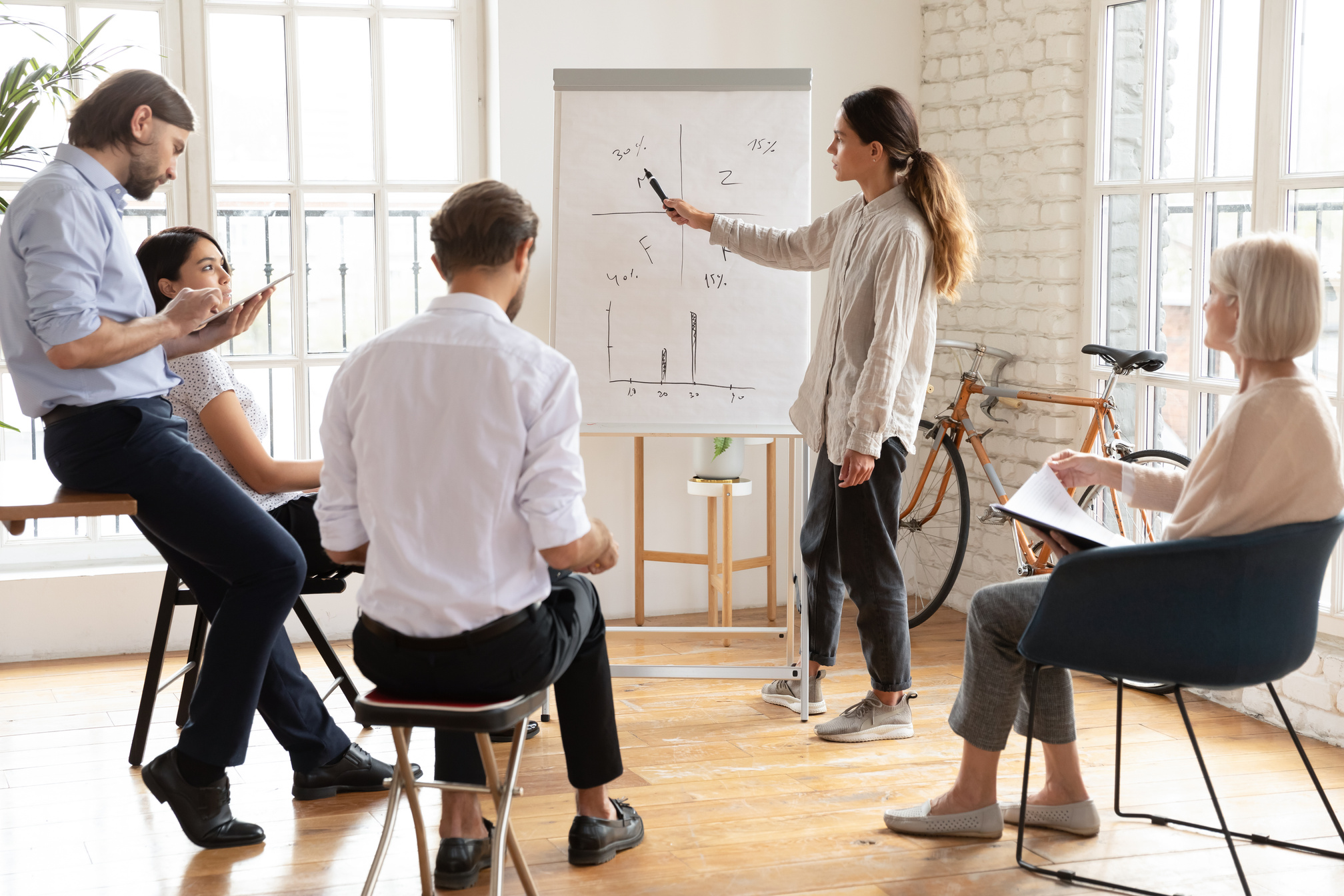 Female Manager Give Presentation at Corporate Workshop